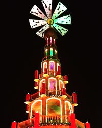 Low angle view of illuminated building against sky at night