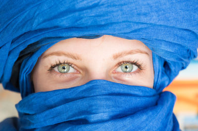 Close-up portrait of a young woman with blue eyes