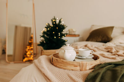 Christmas background. festive breakfast in bed decorated bedroom at home in december christmas tree