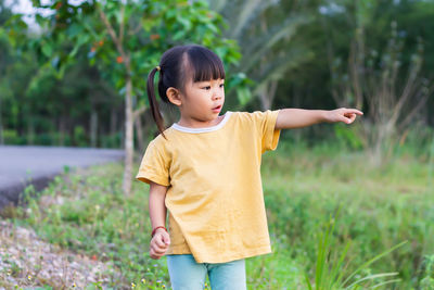 Full length of cute baby girl standing on field