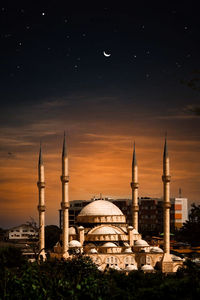 Low angle view of mosque against sky at sunset