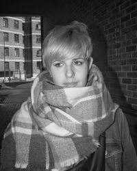 Portrait of teenage girl against brick wall