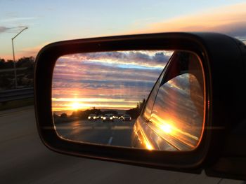 Reflection of clouds in side-view mirror