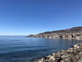 Scenic view of sea against clear blue sky