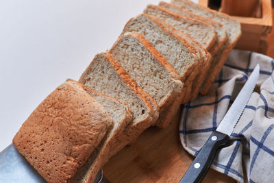 Close-up of bread on table against white background