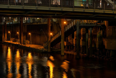 Bridge over river in city at night