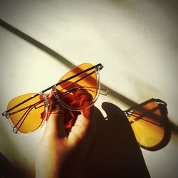 Close-up of hand holding eyeglasses