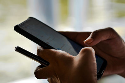 Close-up of hands using phone