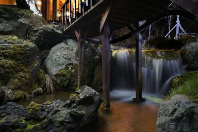 Scenic view of waterfall by river