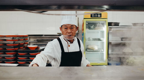 Mid adult man working in restaurant