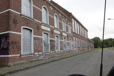 Street by building against sky