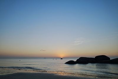 Scenic view of sea against clear sky during sunset