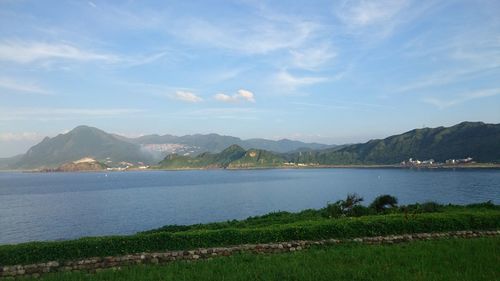 Scenic view of lake against cloudy sky