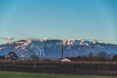 Scenic view of snowcapped mountains against blue sky