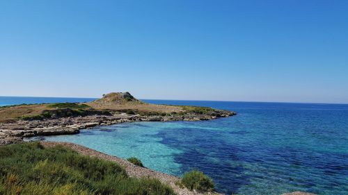 Scenic view of sea against clear blue sky