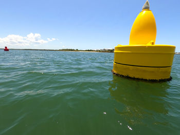 Yellow floating on sea against sky
