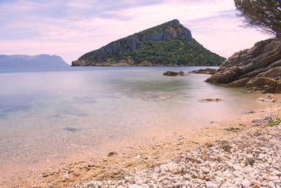 Scenic view of sea and mountains against sky