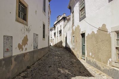 Narrow alley amidst buildings in city