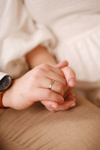 Midsection of couple holding hands