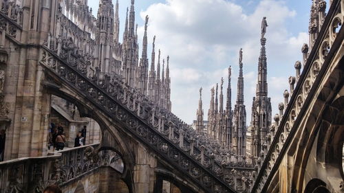 High section of duomo against clouds