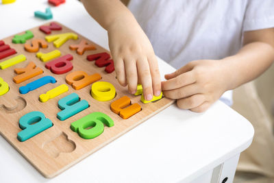 Midsection of man playing with toy blocks