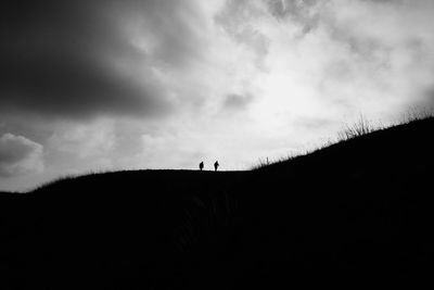 Low angle view of silhouette person against sky