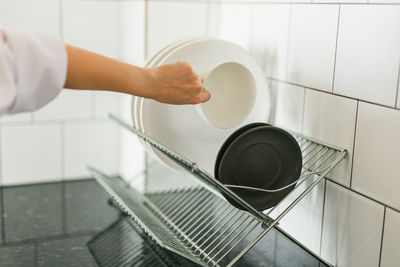 Cropped hand of man working in bathroom