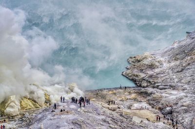 Group of people on rock against mountain