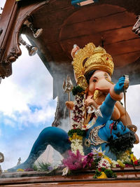 Low angle view of statue against temple