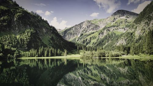 Scenic view of lake and mountains against sky