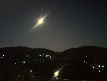 Scenic view of silhouette mountains against sky at night