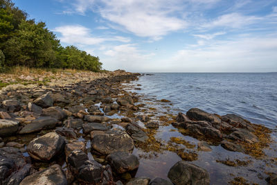 Rocks in sea against sky