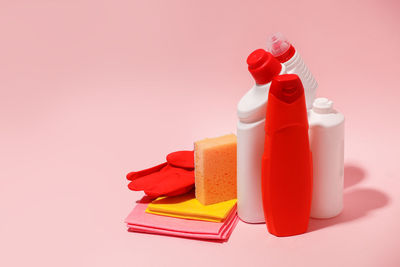 High angle view of multi colored bottles on red background