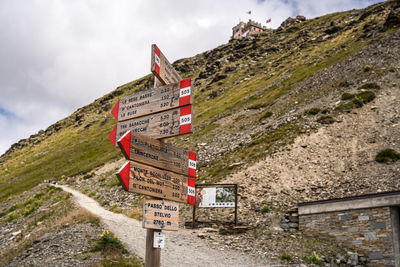 Low angle view of road sign against sky