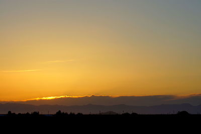 Silhouette landscape against sky during sunset