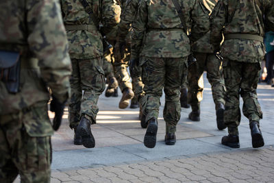 Rear view of marching soldiers in full uniform.