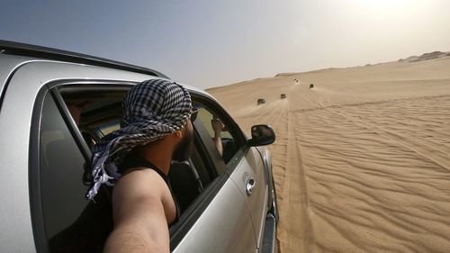 Rear view of man driving car