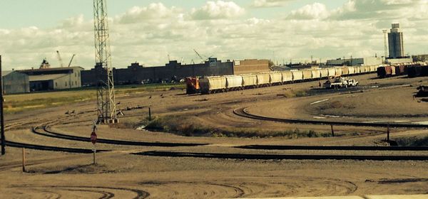 Trains at shunting yard against sky