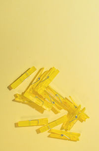 Close-up of yellow colored pencils over white background