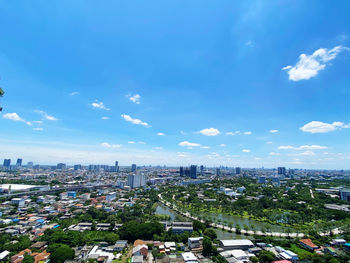 High angle view of city against blue sky