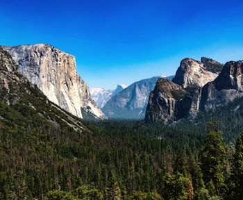 Scenic view of mountains against clear blue sky