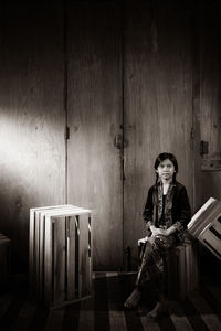 Portrait of young woman sitting on seat