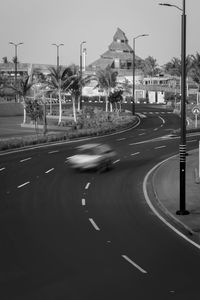 Blurred motion of city street against sky