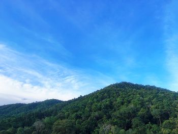 Scenic view of mountains against blue sky