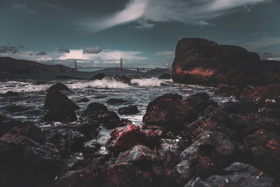 Rocks in sea against sky