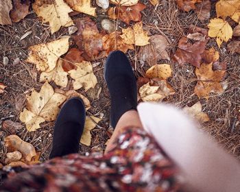 Low section of person on autumn leaves