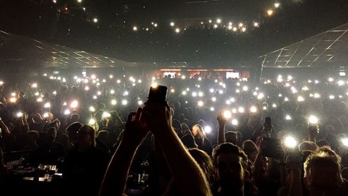 People enjoying music concert at night