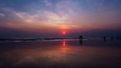 Scenic view of beach against sky during sunset