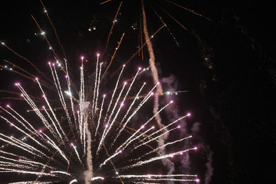 Low angle view of firework display at night
