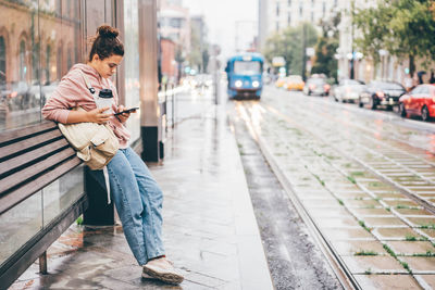 Side view of young woman standing on street